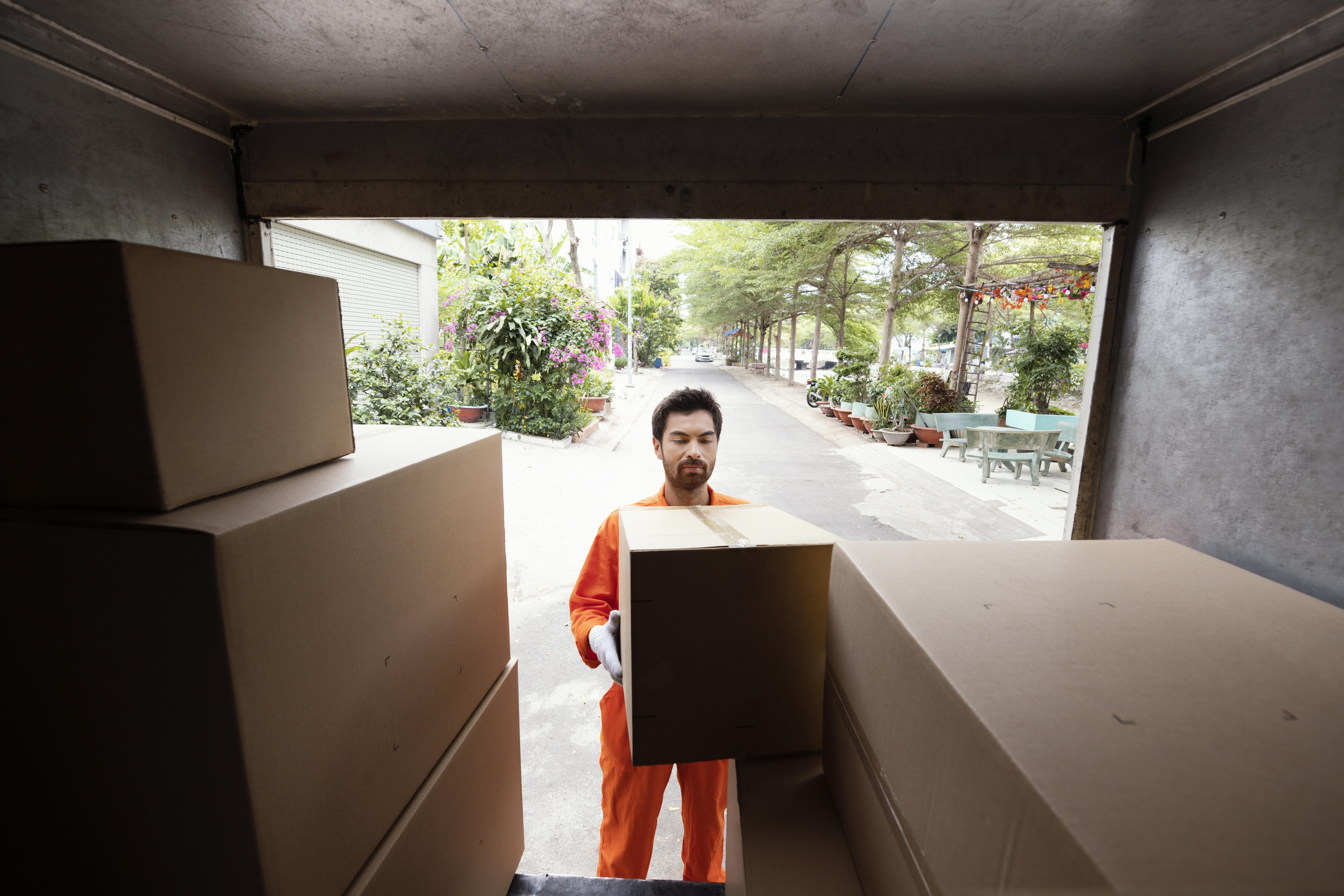 delivery-man-loading-car-with-parcel-boxes