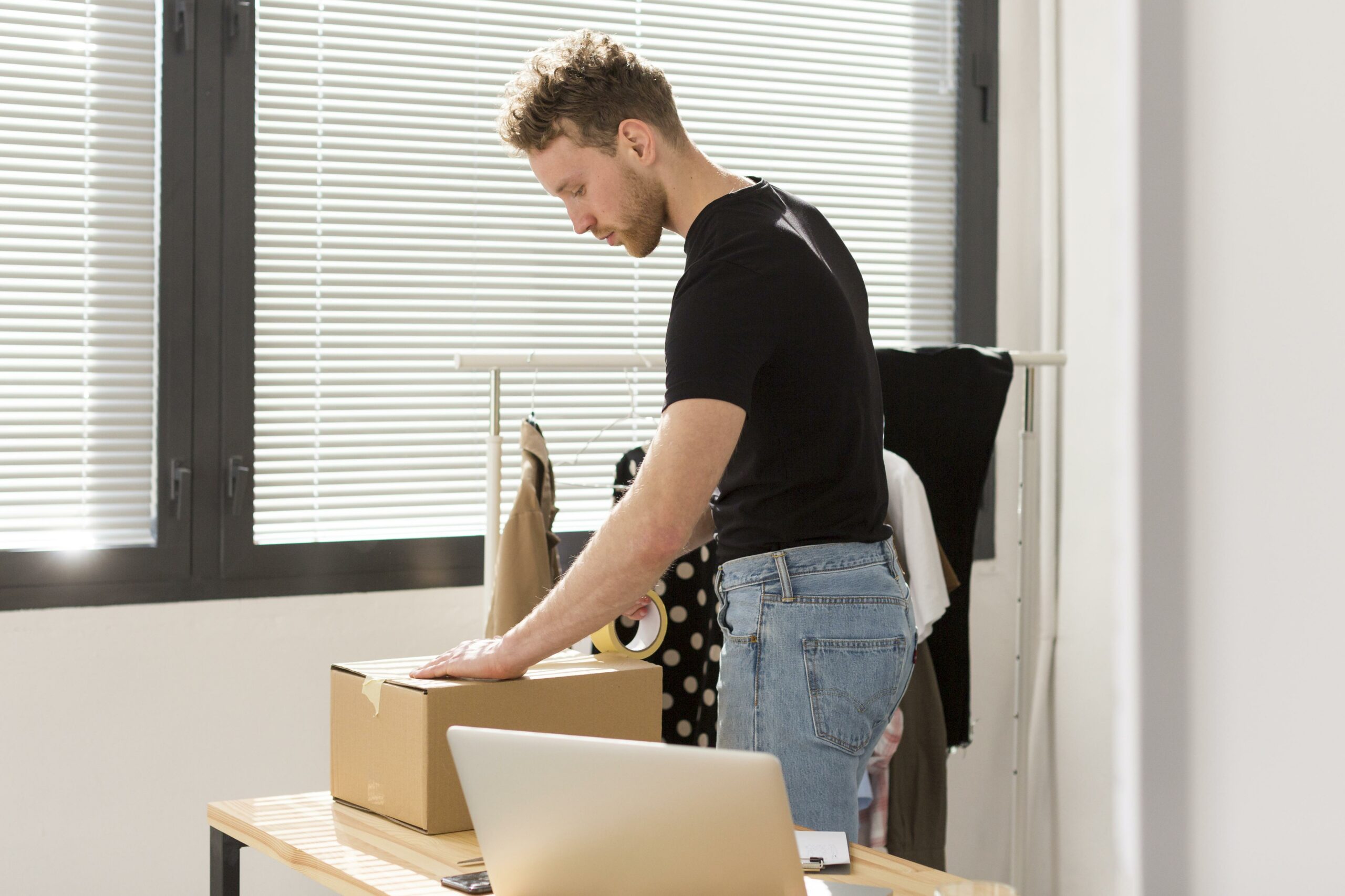 side-view-man-packing-box